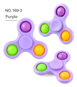 Three purple fidget spinners with colorful pop-it bubbles on a white background