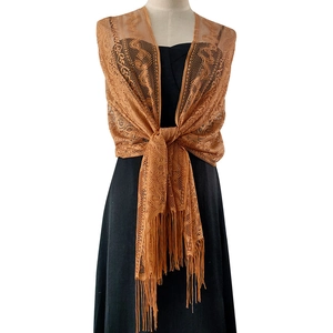 Close-up of caramel lace shawl with fringe detailing worn on a formal black dress