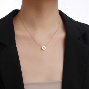 Elegant gold titanium necklace with Roman numeral ring pendant and single zircon stone