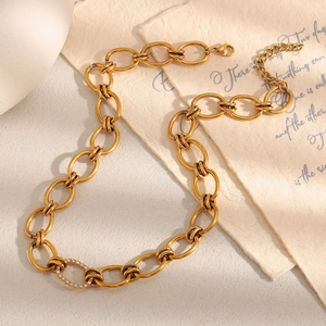 Detail of 18K gold-plated stainless steel chain necklace with a sparkling zircon ring pendant