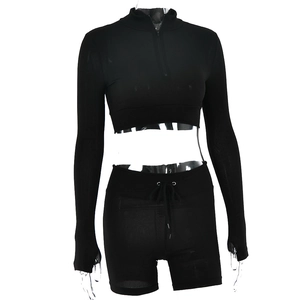 Detail of black long sleeve zipper crop top and drawstring shorts with ribbed texture fabric