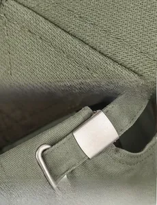 Detail of adjustable metal buckle strap and durable cotton stitching on olive green baseball cap