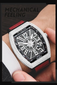 Close-up of tonneau watch with silver iced-out case and red silicone strap