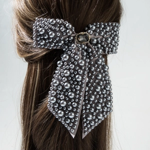 Elegant dark grey bridal hair clip with faux pearls and a large center crystal stone