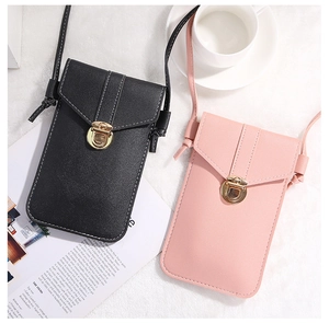 Detail view of stylish cross-body phone bags in black and pink with metal buckle