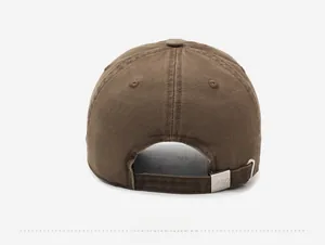 Detail view of brown washed cotton baseball cap featuring adjustable silver metal buckle