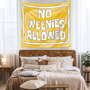 Detail of yellow wall tapestry with No Weenies Allowed slogan for home decor