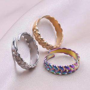 Detailed view of twisted adjustable rings in silver, gold, and rainbow finishes