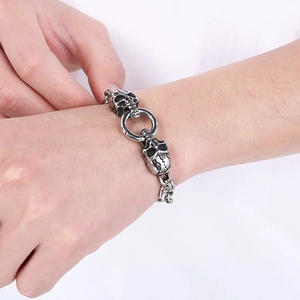 Detailed view of punk double skull clasp on a retro silver stainless steel bracelet