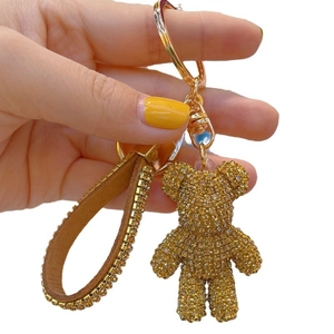 Sparkling gold rhinestone bear keychain with brown leather strap and metal ring