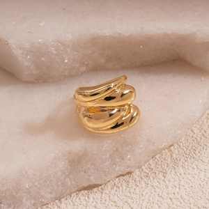 Macro shot of gold organic liquid metal ring with high-polished mirror finish and wide band