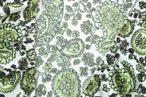 Close-up of green paisley floral fabric with unique crinkle texture and pleated detail