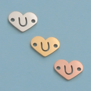Detailed view of 12mm stainless steel heart pendants in silver gold and rose gold