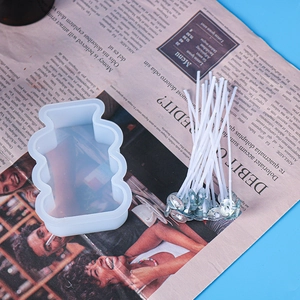 DIY candle kit featuring a clear geometric silicone mold and cotton wicks with metal bases