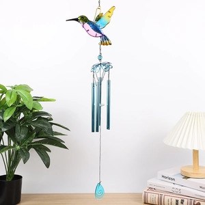 Detail view of colorful glass hummingbird wind chime with blue tubes and teardrop pendant