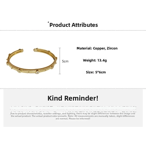 Detail of vintage gold plated cuff bracelet with brushed texture and zircon stones