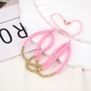 Detailed close-up of pink faceted beads with adjustable braided cord bracelets for women