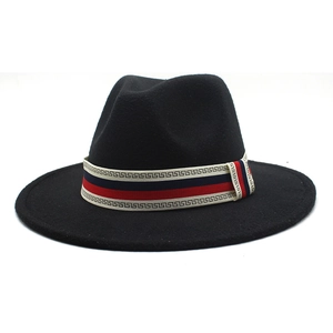 Close-up of black wool fedora with a red, white, and blue patterned decorative band
