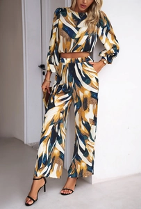Detail view of stylish two-piece set featuring abstract print top and wide-leg trousers