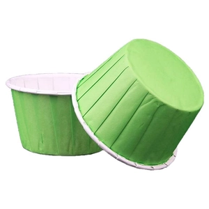 Set of bright green large rolled edge paper muffin cups for baking on white background