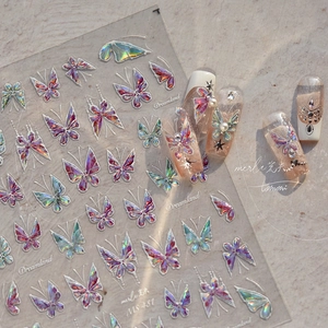 Iridescent 3D butterfly nail art decals with holographic metallic effect on stone surface