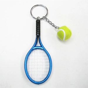 Detail of a blue metal tennis racket keychain with a mini yellow neon felt tennis ball