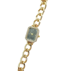Elegant gold chain watch with a rectangular diamond-encrusted bezel and dark grey dial