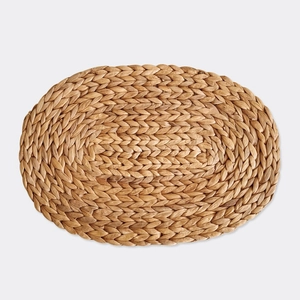 Oval handmade water hyacinth placemat with natural woven texture and heat resistance