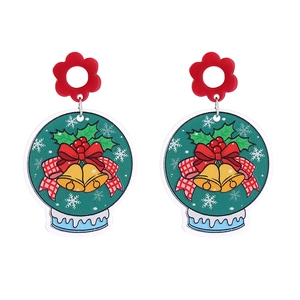 Detailed close-up of acrylic Christmas earrings with glitter bells and holly patterns