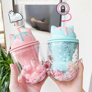 Close-up of cat paw double-walled straw cup with stars and pink petal sequins