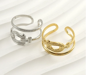 Close-up of adjustable buckle rings in gold and silver finish with dotted metal band