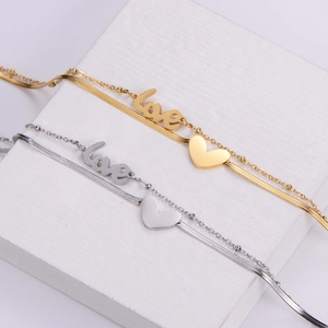 Double-layered gold and silver snake chain bracelet with love heart pendants
