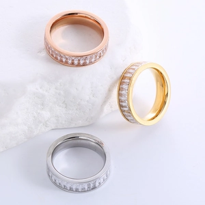 Three minimalist stainless steel eternity rings with baguette-cut cubic zirconia stones