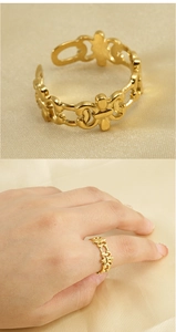Detailed macro view and hand model shot of a gold open ring with baroque cutout patterns