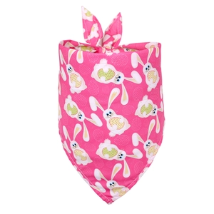 Close-up of pink Easter dog bandana with cartoon rabbit and egg patterns