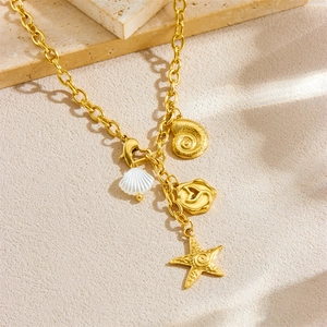 Gold stainless steel link necklace with starfish, seashell, and conch charms on stone