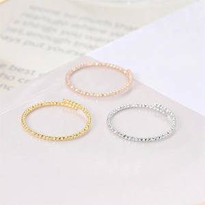 Detail of twisted rope texture on adjustable titanium steel rings in three colors