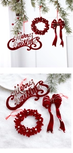 Close-up of dark red flocked Merry Christmas hanging ornaments with silver glitter detail