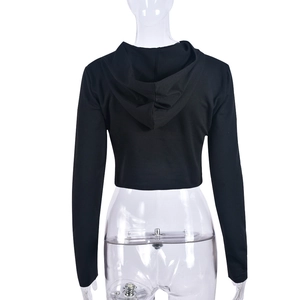 Detail view of back design for black cropped hoodie showing knit texture and hood structure