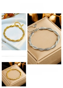 Detail of twisted cable chain bracelets in gold and silver finish stainless steel
