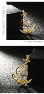 Detailed macro view of golden anchor brooch featuring premium sparkling zircon crystal inlay