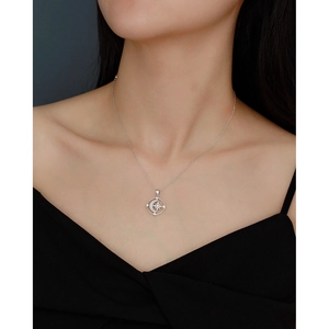 Detailed close-up of a silver moon and star pendant necklace with sparkling zircons