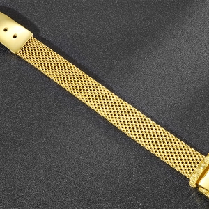 Macro shot of gold stainless steel snake bone mesh texture on a stylish men's bracelet
