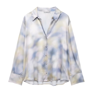 Detailed view of the tie-dye satin shirt with blue and yellow ink texture and long sleeves