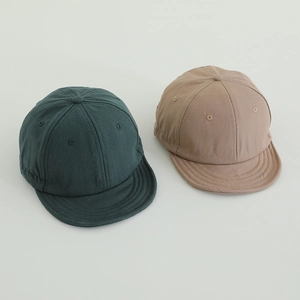 Top view of two retro short brim kids baseball caps in dark green and khaki colors