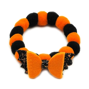 Detail of Halloween pet collar with orange and black plush balls and sequin bat wings