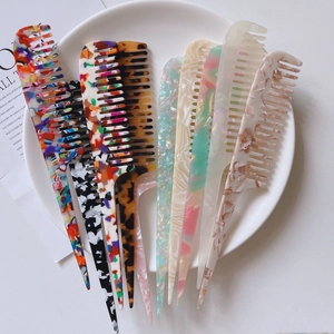 Macro detail of various marble pattern acetate hair combs for professional styling