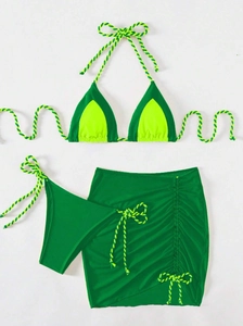 Detailed flat lay of a three-piece bikini set with green fabric and neon yellow cords