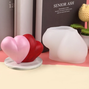 Detailed view of translucent heart-shaped silicone mold and DIY resin craft on marble base
