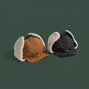 Winter lamb wool trapper hats in black and tan with windproof shell and ear flaps